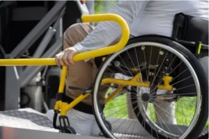wheelchair user on a wheelchair on a hydraulic lift platform